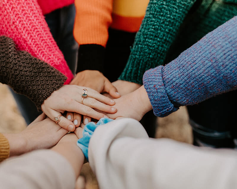 People putting their hands in a circle